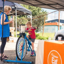 Kid on exercise bike at CCFM market